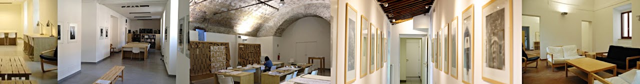 Interior views of the renovated monastery: white galleries with framed prints, a vaulted stone workroom with worktables, a corridor of framed artwork, and a sitting room